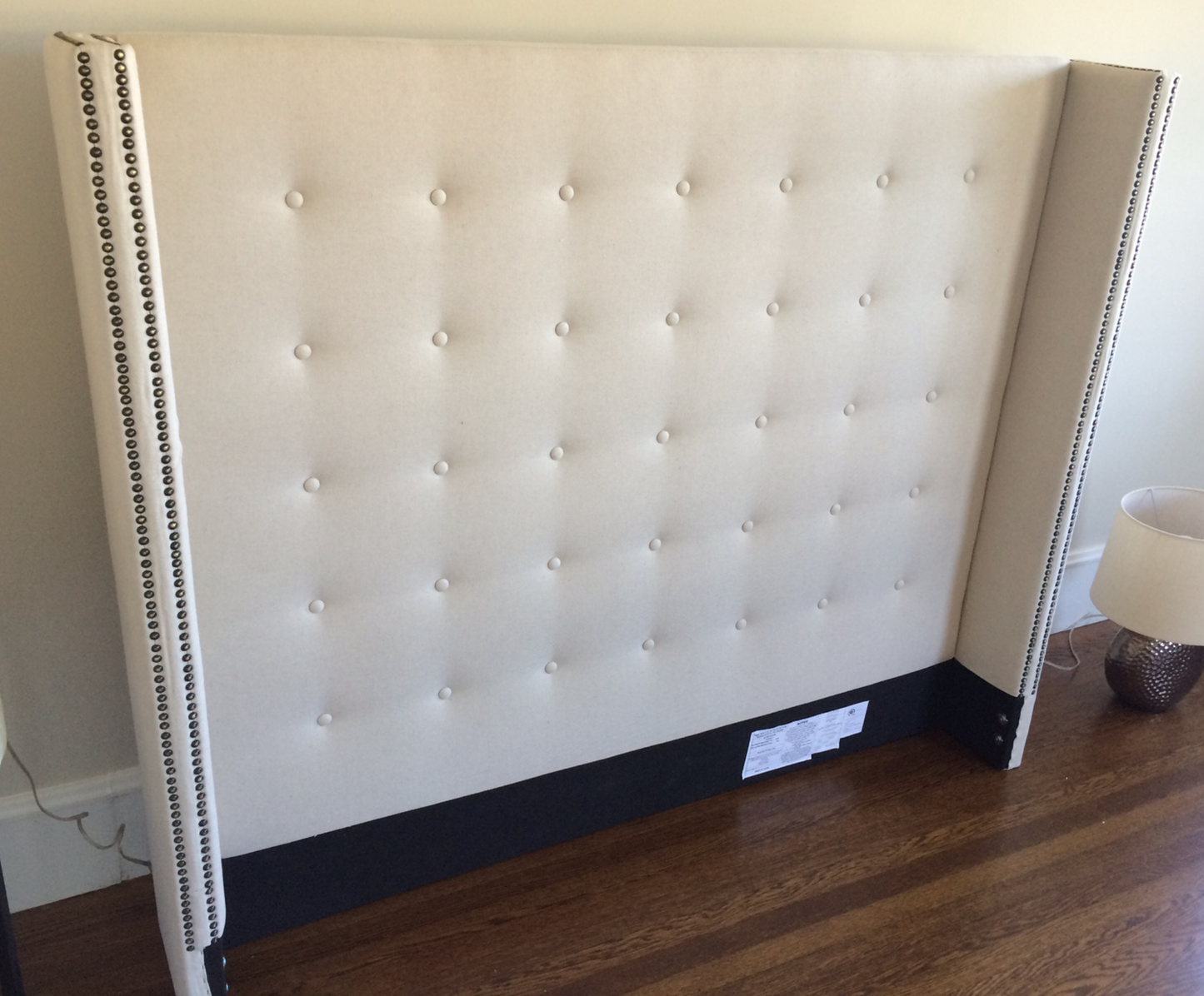 King bed frame, shelter bed style, cream button tufted with antique brass nailhead trim