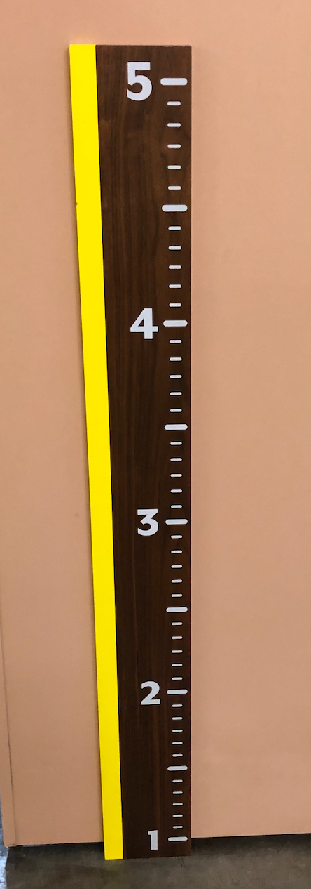 Child's growth chart decor with yellow stripe