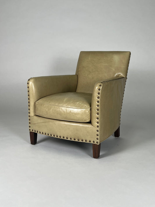 Parchment colored leather chair with nailhead trim