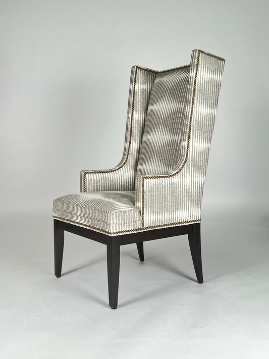 Modern wing back chair with gray and white patterned fabric, nailhead trim