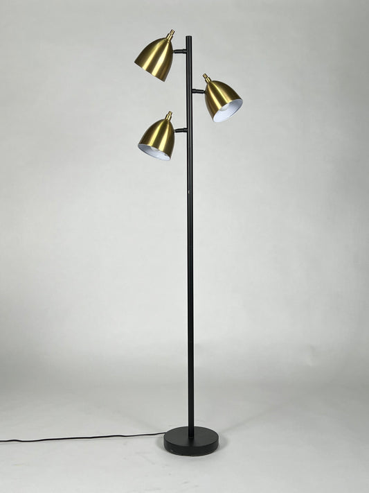 Floor lamp with black pole and three brass heads