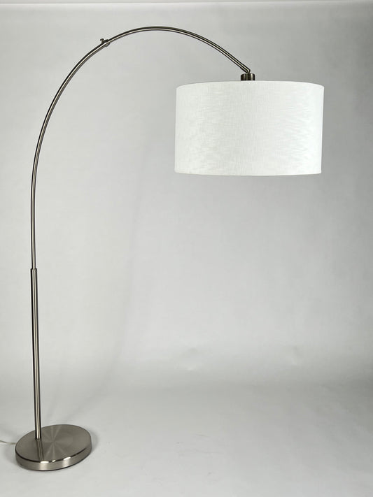 Silver metal arc floor lamp with cream shade