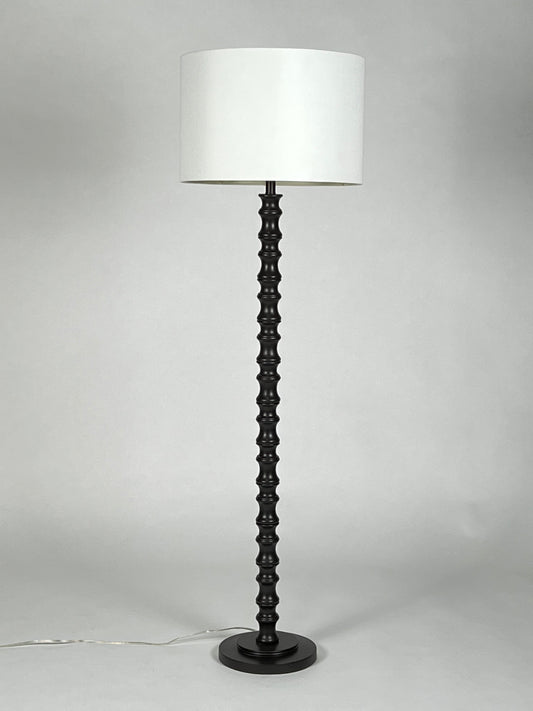 Black turned wood floor lamp with cream shade