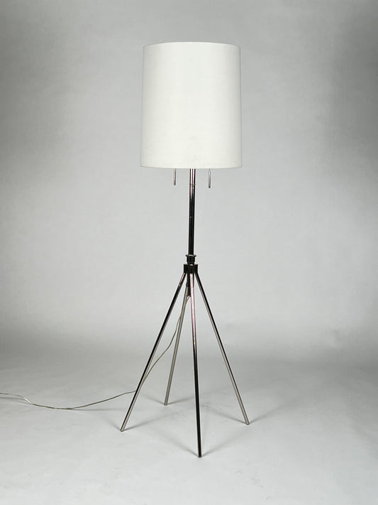 Chrome four legged floor lamp with white shade