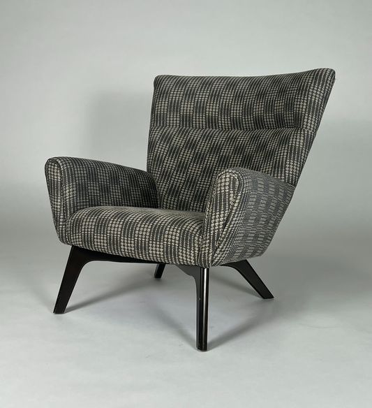 Gray and charcoal patterned atomic chair, mid century styling, black angled legs.