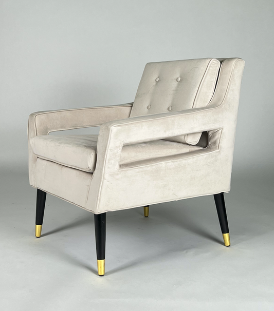 Cream velvet square arm chair with black legs and brass tips