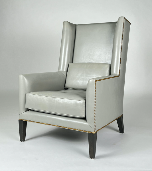 Gray leather wing back chair with nailhead trim