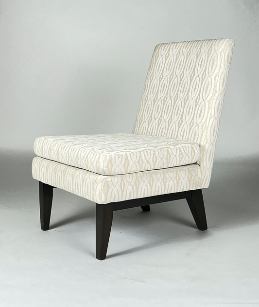 Cream and pale yellow patterned fabric slipper chair with high back and dark legs