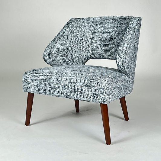 Blue and white herringbone patterned fabric chair with rounded back and dark legs