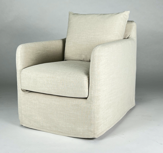 Cream slipcovered swivel chair