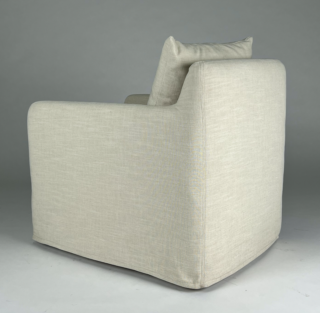 Cream slipcovered swivel chair