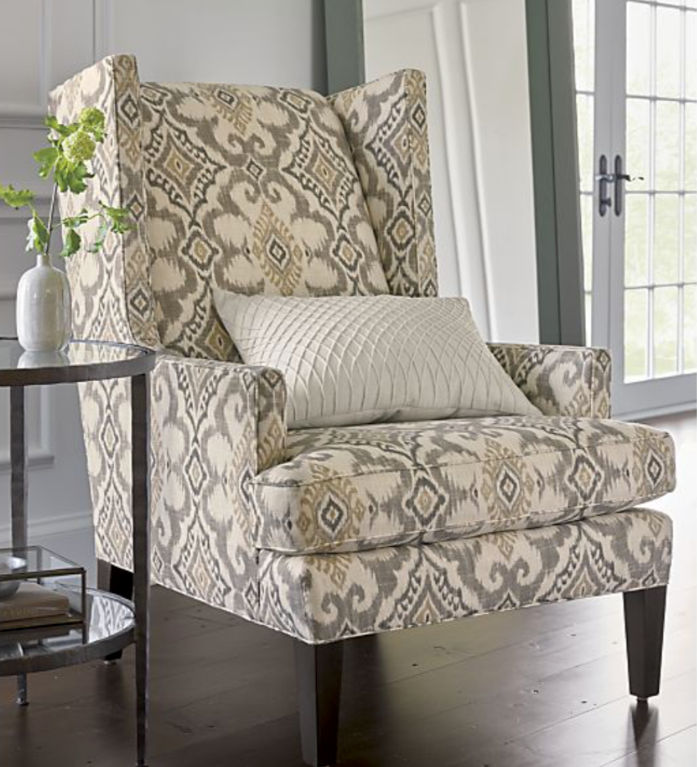 Patterned fabric wing chair in cream, tan, olive with black legs