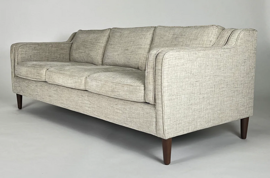 Light gray tweedy sofa with sweep arms