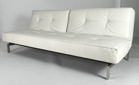 White tufted leather armless sofa