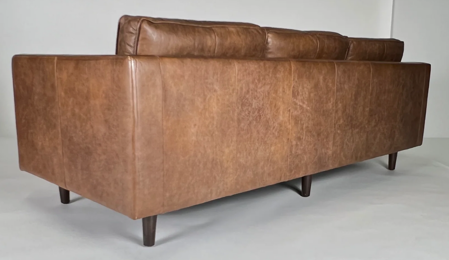 Brown leather sofa with bolsters