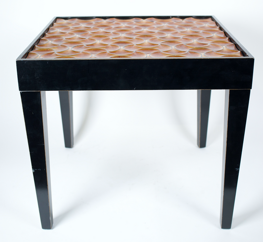 Side table with black wood frame and orange patterned top