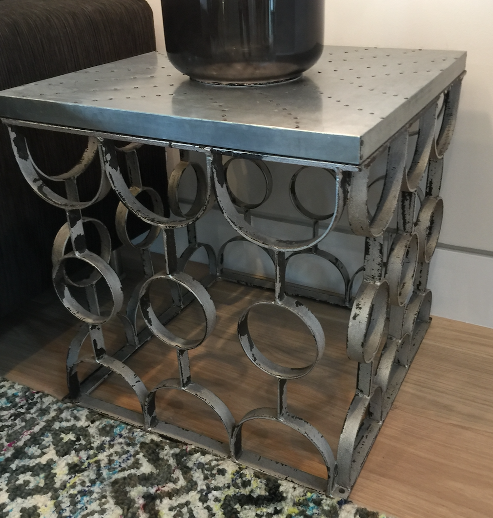 Matte metal side table, with nailed surface