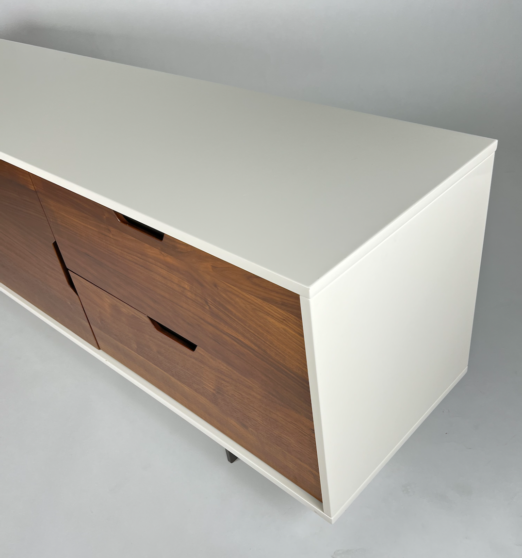 Gloss white cabinet with warm wood front, metal base and legs