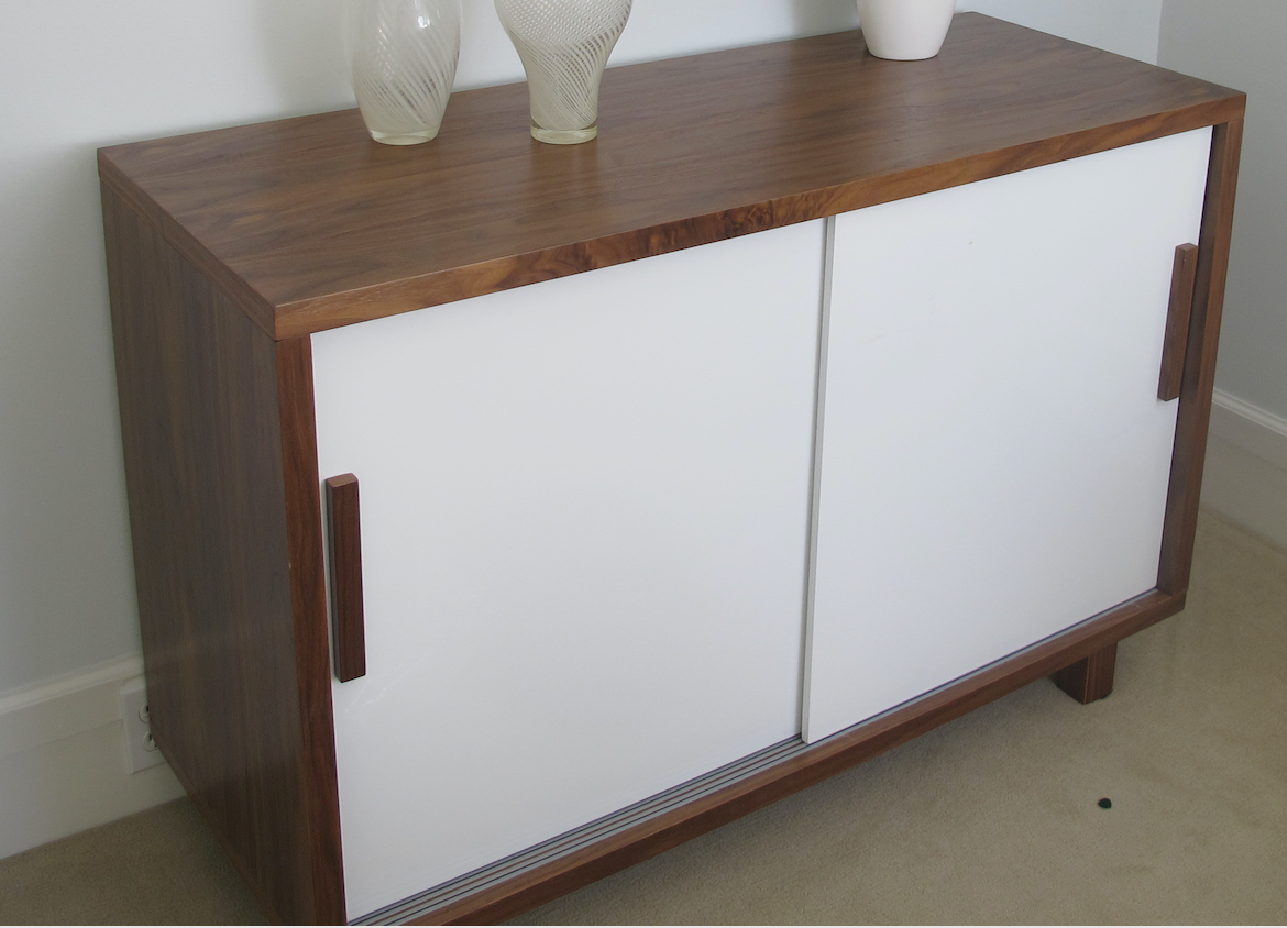 Warm wood case with white sliding doors