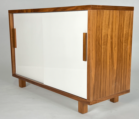 Warm wood cabinet with white sliding doors