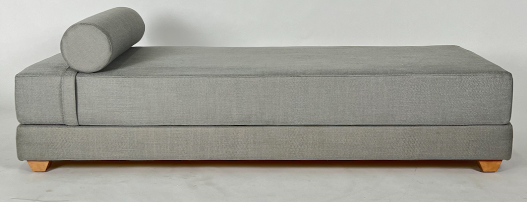Silvery gray fabric daybed with bolster, unfolds into a bed for two