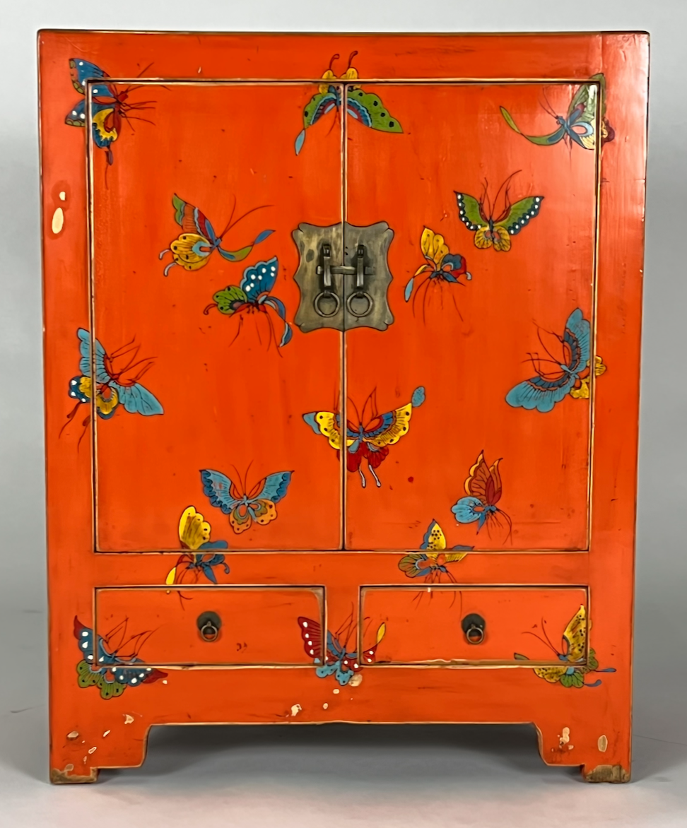 Vintage orange cabinet with painted butterflies