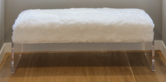 White faux fur bench with clear acrylic slab legs