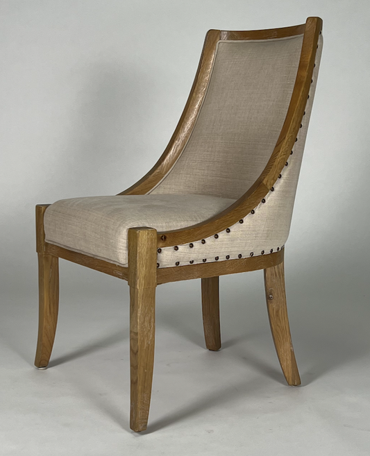 Sweep area wood frame chair with light tan upholstery, nailhead trim