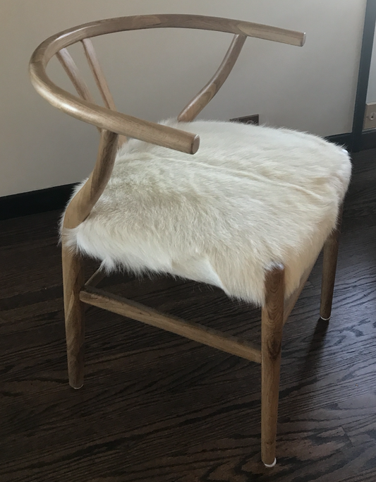 Blonde wishbone chair with white goat hair seat