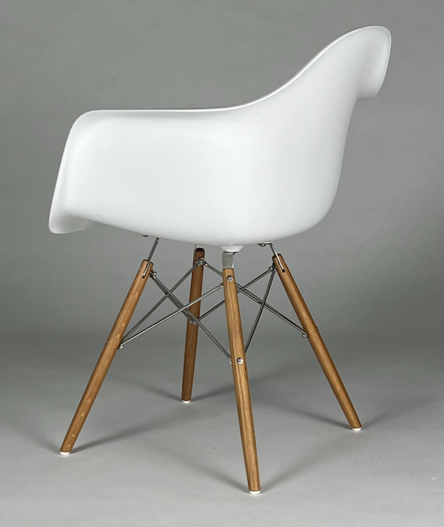 White Eames like bucket chair with arms and wood legs