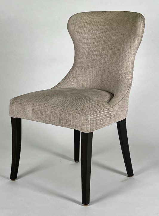 Taupe upholstered chair with black legs