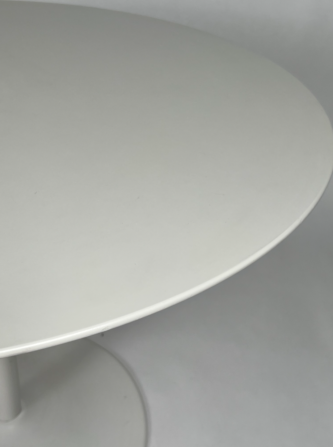 Round white dining table with pedestal base