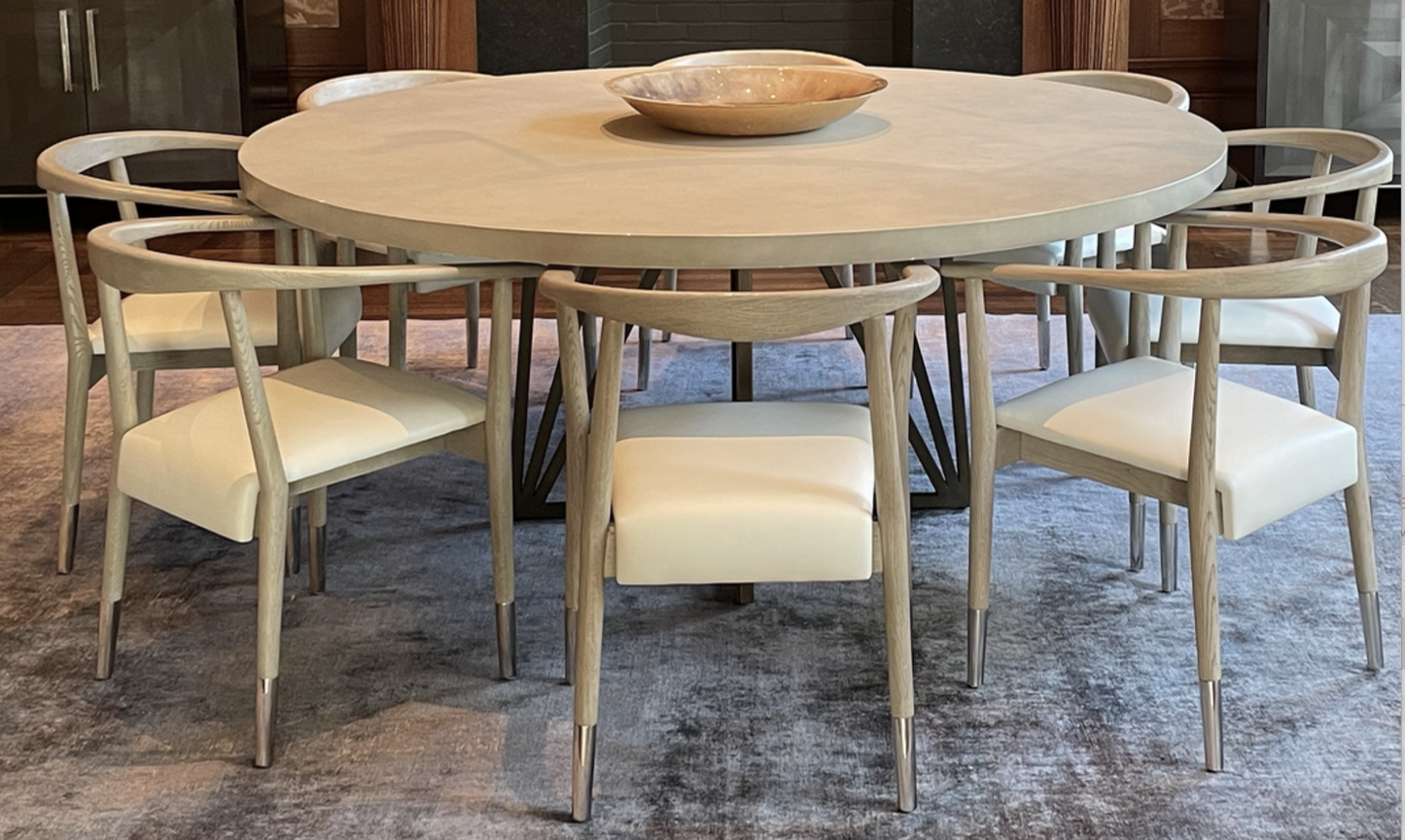 Pale gray concrete finished round top dining table, black steel base