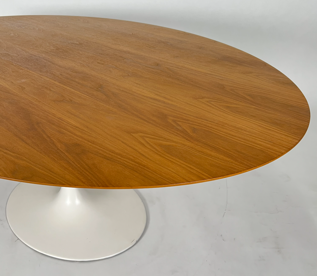 Oval walnut Saarinen like dining table with white pedestal base