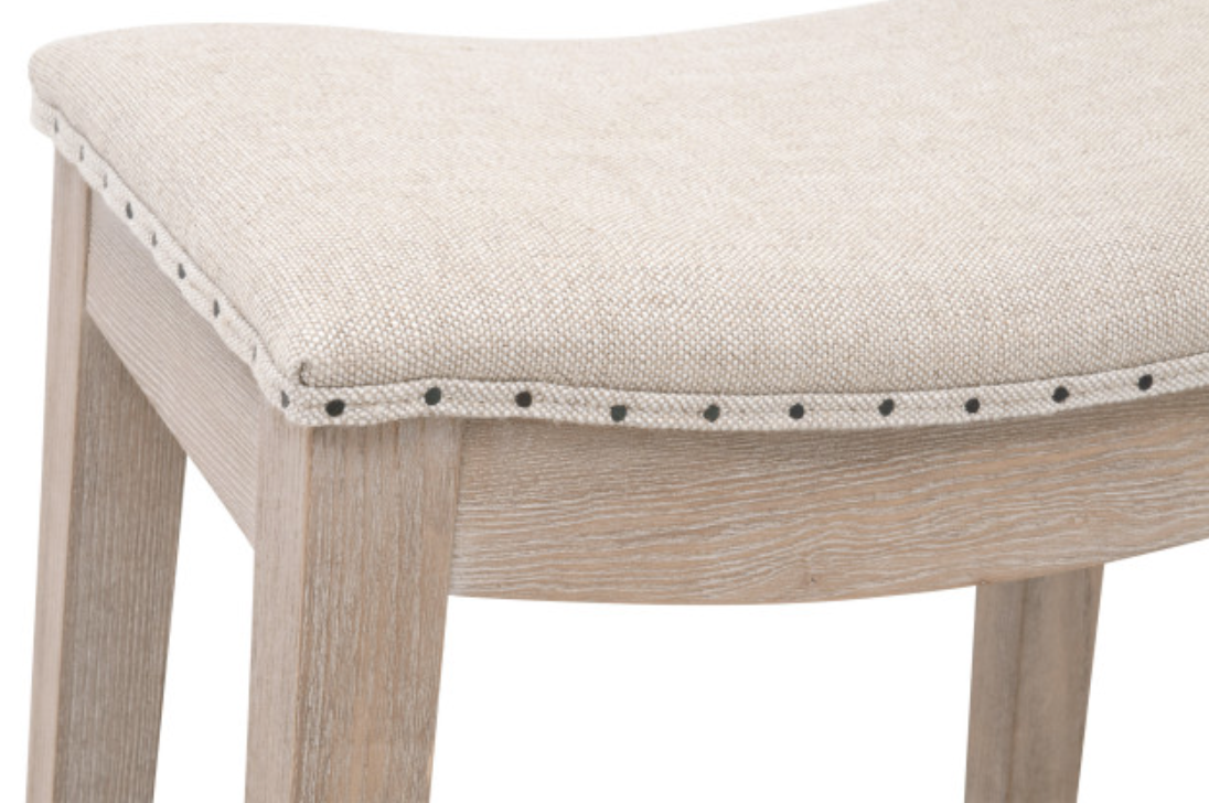 White washed wood counter stool with linen seat, nailhead trim