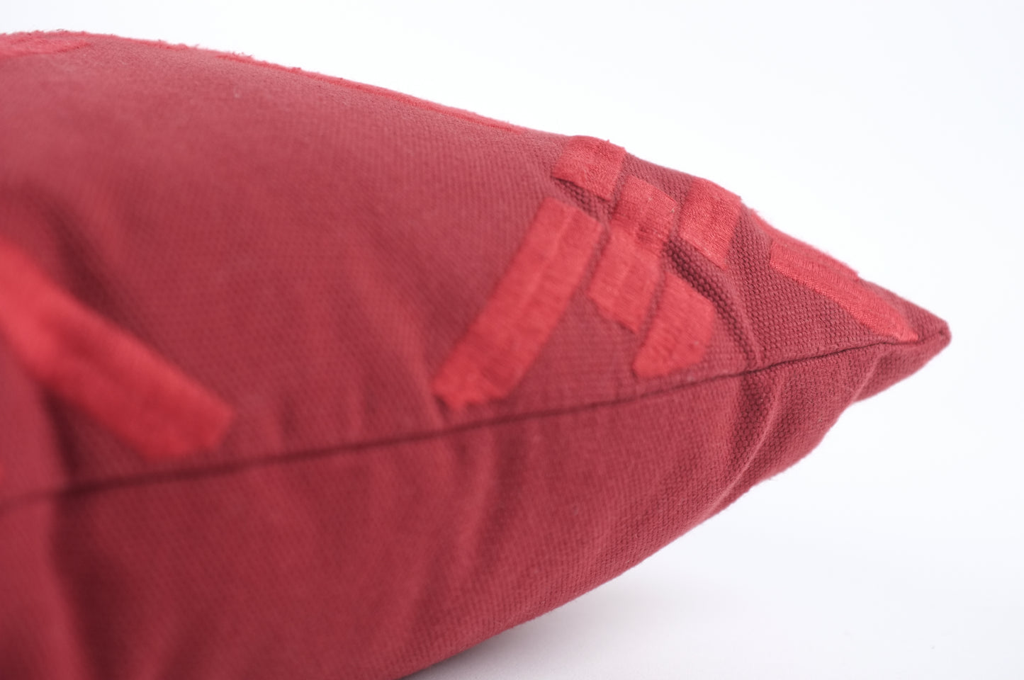 Red lumbar pillow with chain link pattern