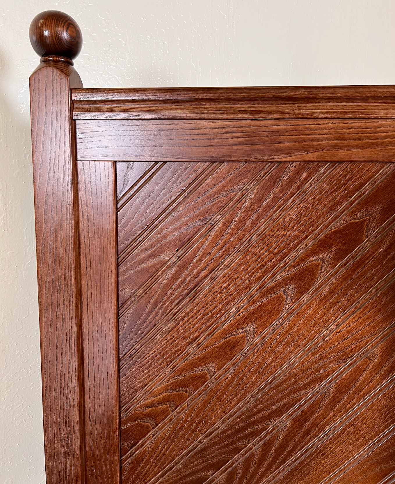 Brown wood twin bed with finials