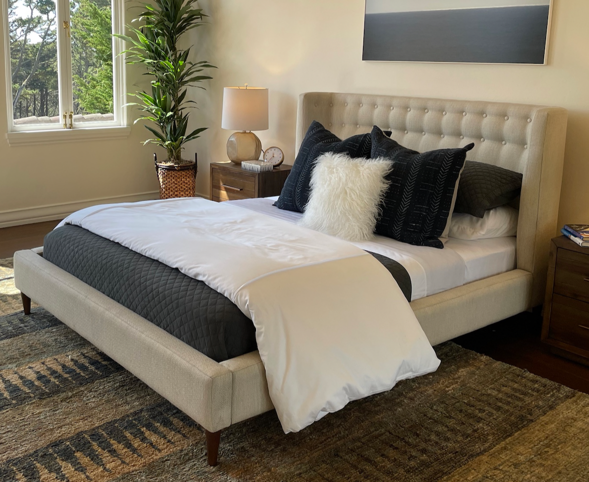 Queen cream upholstered curved shelter bed