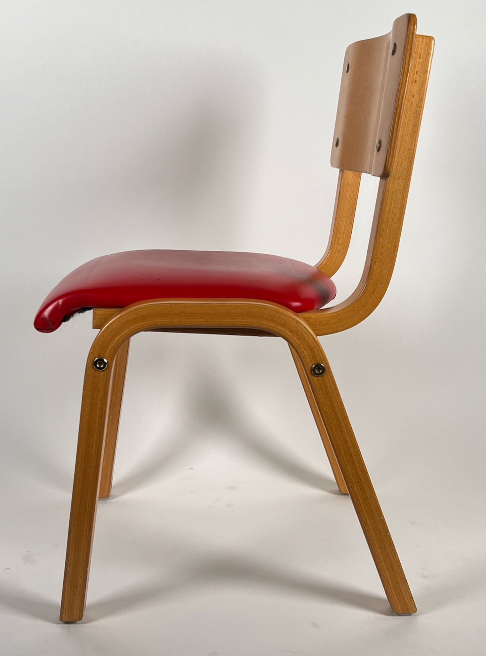 Vintage child chair with red seat