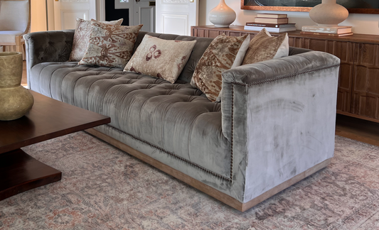 Brown tufted velvet library sofa with aged bronze nailhead trim