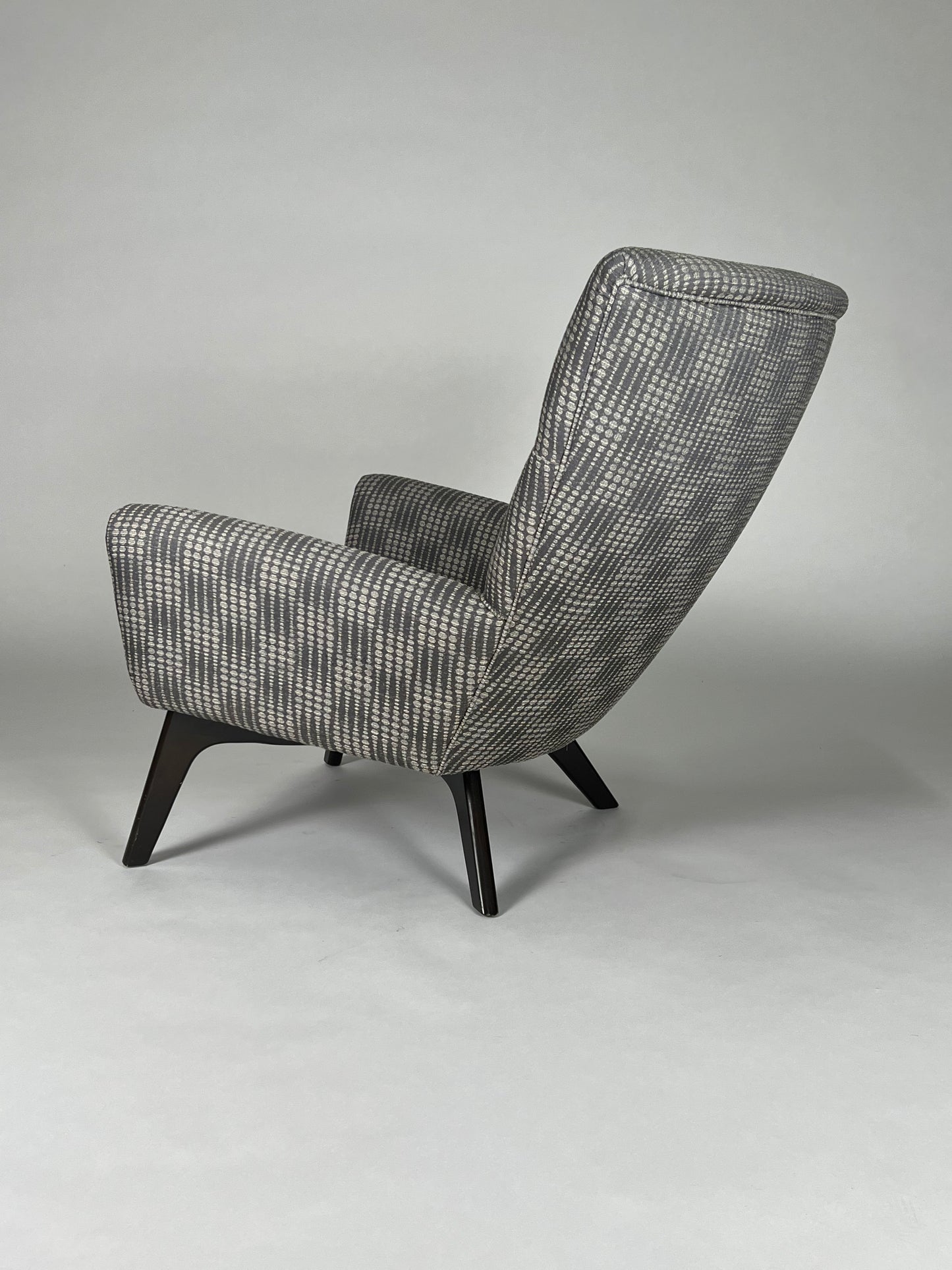 Gray and charcoal patterned atomic chair, mid century styling, black angled legs.