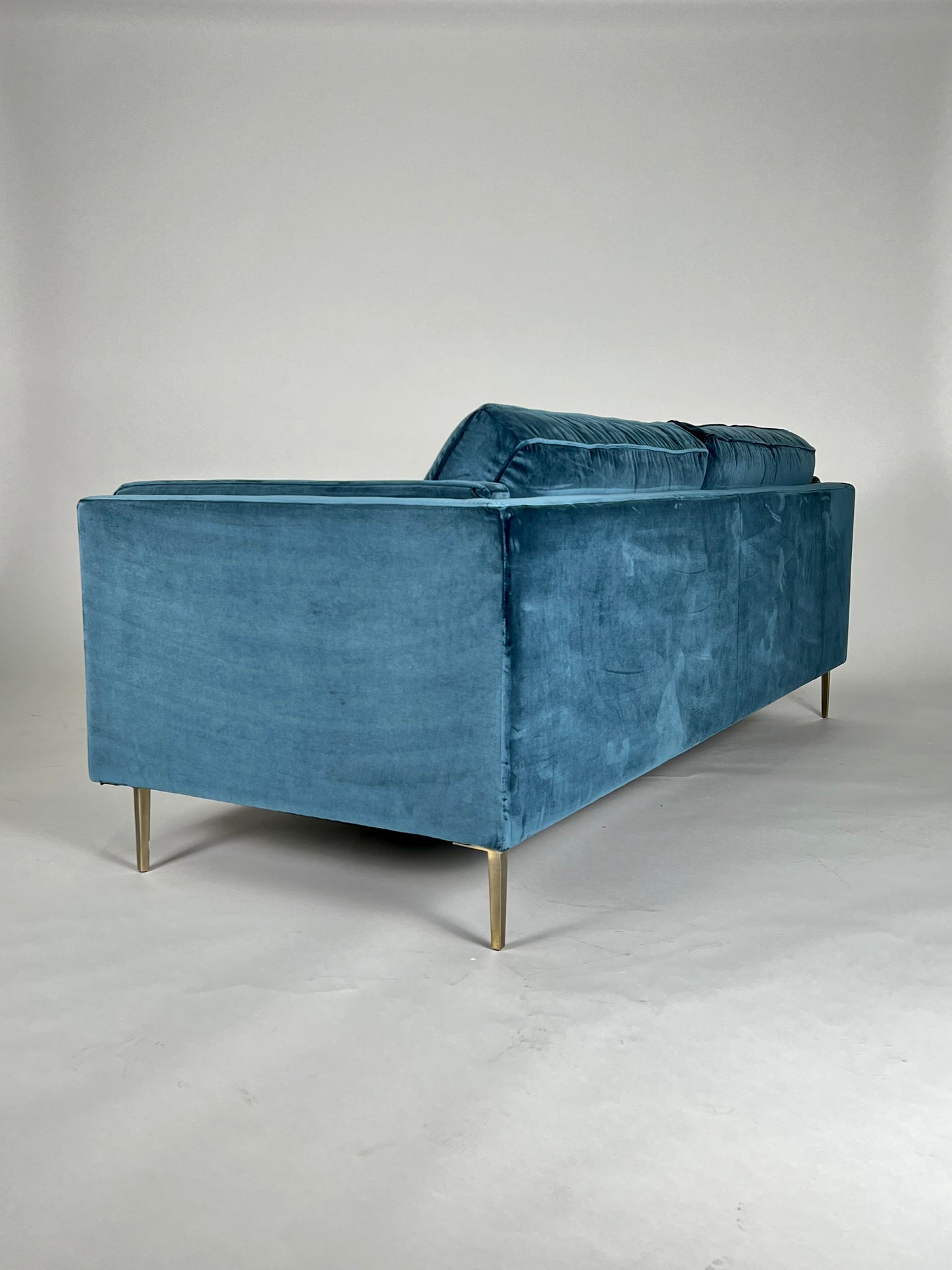 Sapphire / teal blue velvet sofa with brass legs, mid-century styling