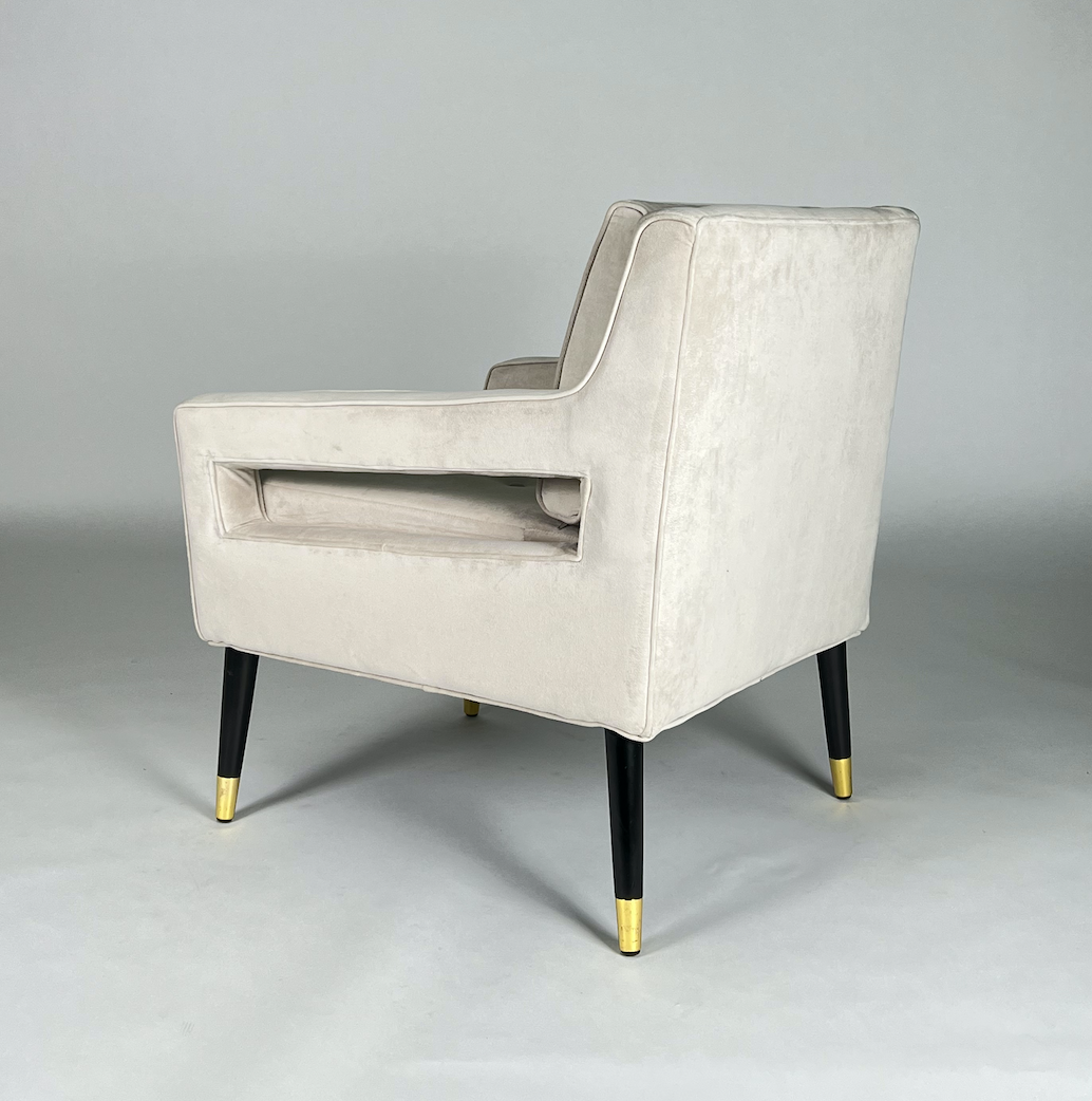 Cream velvet square arm chair with black legs and brass tips