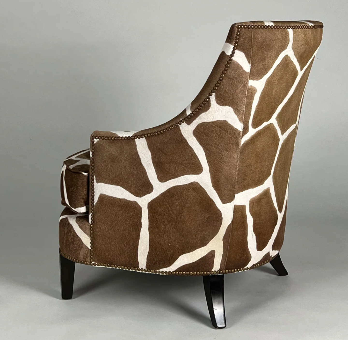 Hair on hide, brown and cream, giraffe print chair with dark brown legs.