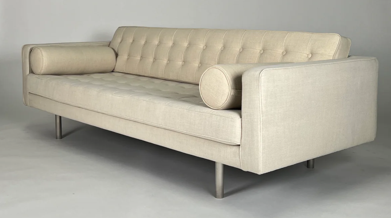 Cream tight back sofa with 2 bolsters, chrome legs