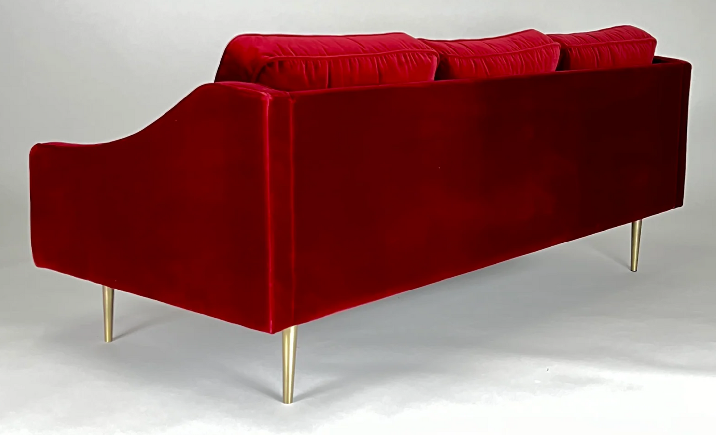 Red velvet sofa, brass legs, mid-century styling