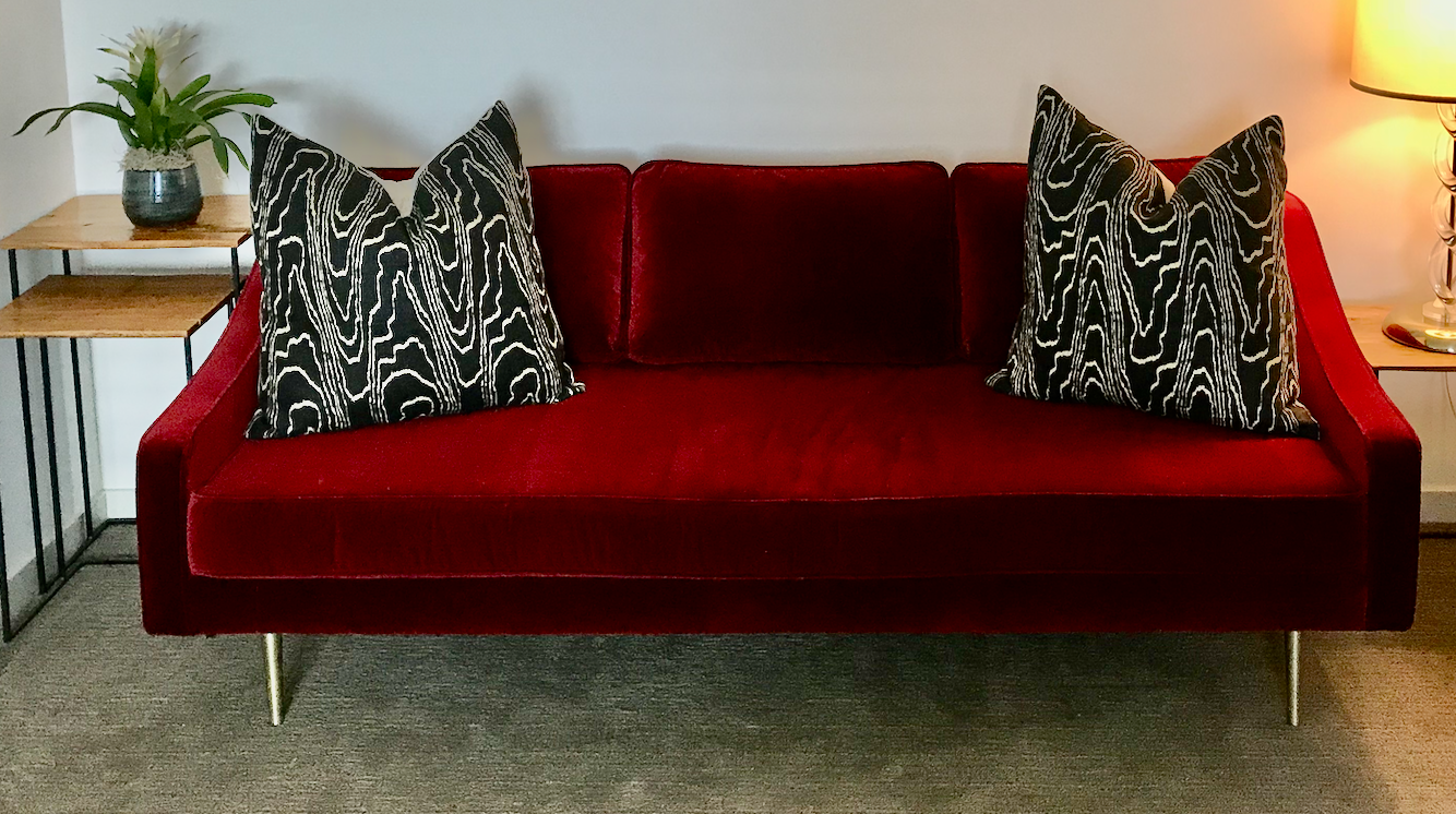 Red velvet sofa, brass legs, mid-century styling