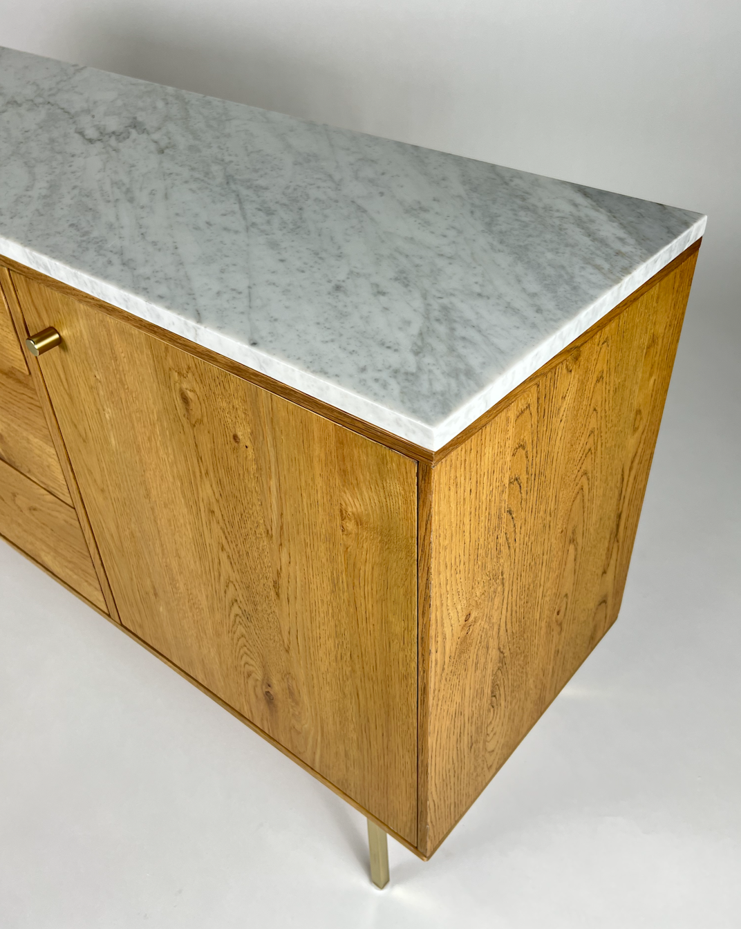 Marble top, light oak media cabinet with brass legs