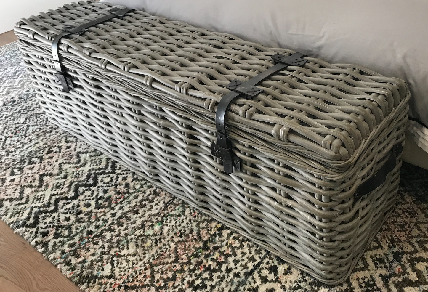 Gray rattan truck with leather straps