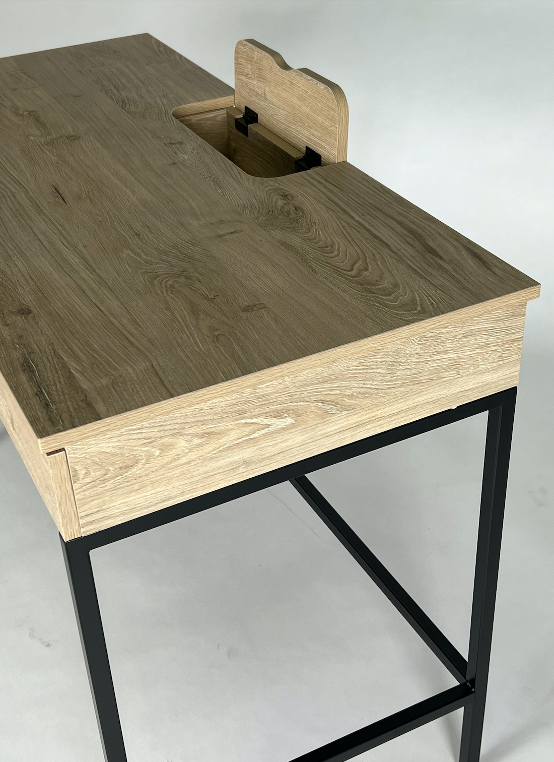 Light wood desk with black frame